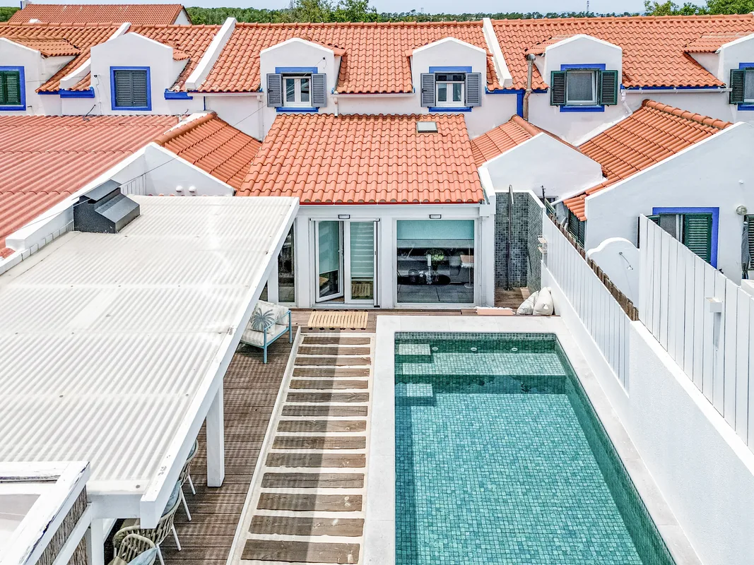 Aerial view of Comporta village with terracotta rooftops and salt pans near the property