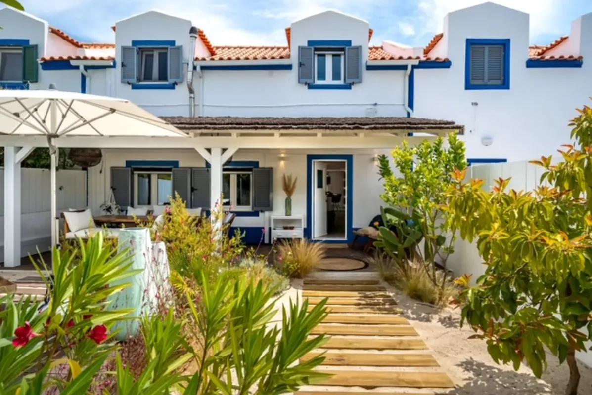 Whitewashed Comporta village house with blue trim and terracotta roof