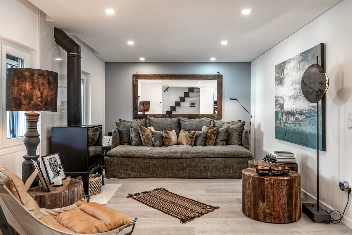 Living room with wood-burning stove and leather chaise at Comporta Village House, a holiday rental in Comporta, Portugal